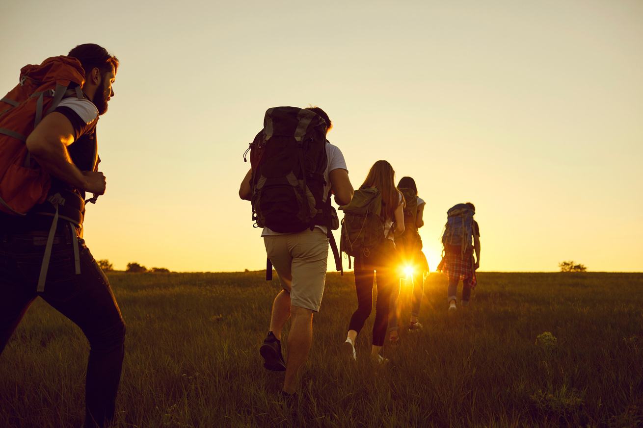 Hikers walking at sunset