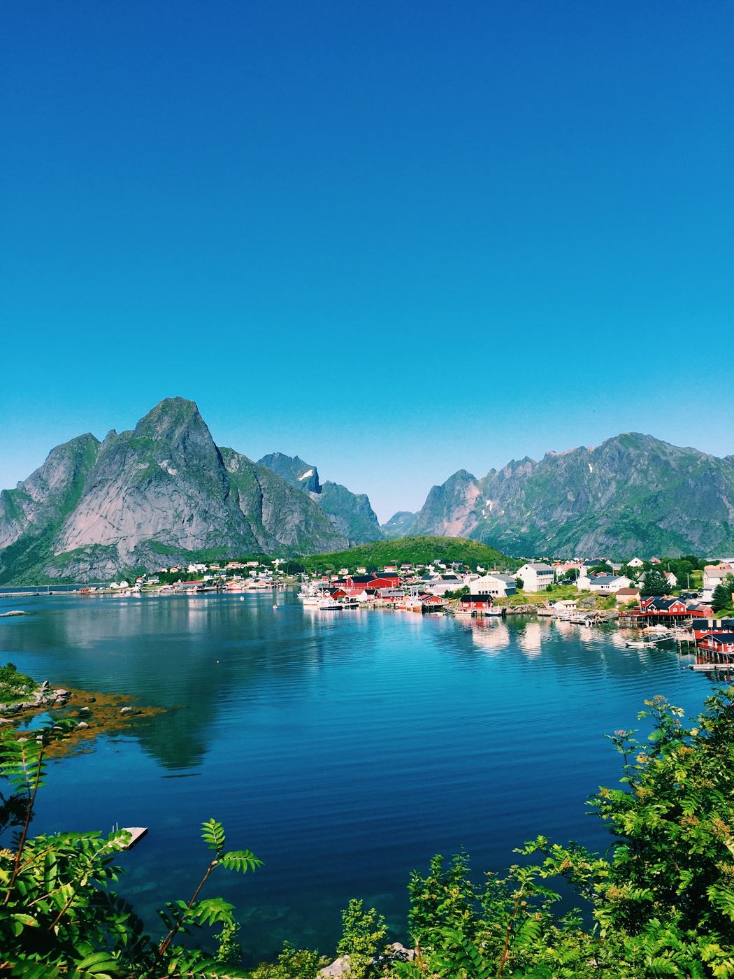 Lakeside village beneath mountains